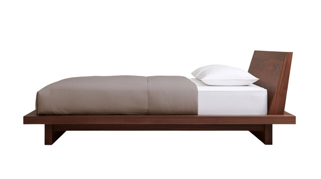 Modern wooden platform bed with taupe duvet and white pillow