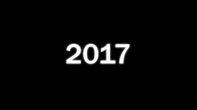 White glowing numbers representing the year 2017 centered on a solid black background for a simple minimalist calendar or time related
