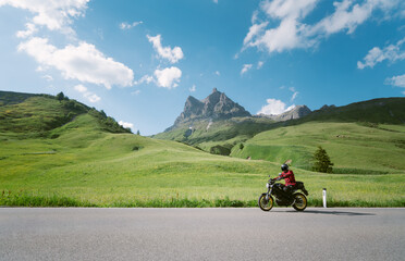 Motorcyclist riding on alpine mounain road in the Alps in summer © JFL Photography