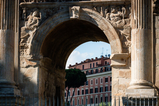View of Roman apartment building through the ancient Arch of Constantine