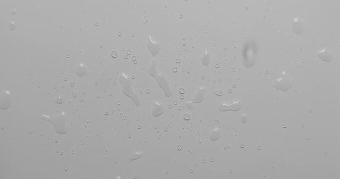 Close up water droplets on a white surface. Can be used as background for design projects. 