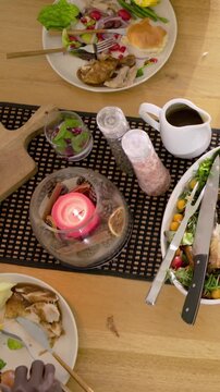 Vertical video: Serving after plates set two diners mustard cuff sharing at home table adding beans