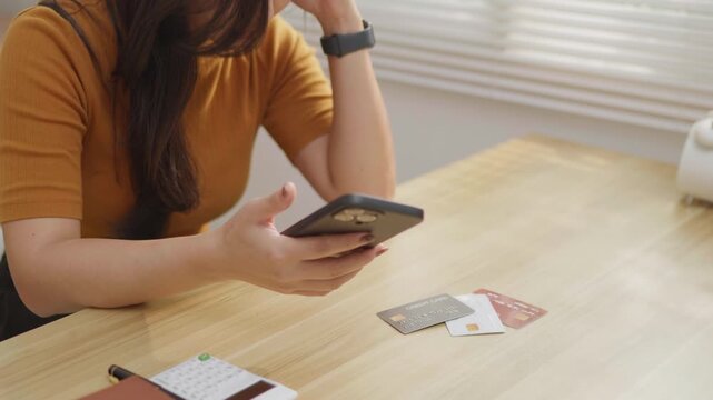 Woman stressed while holding multiple credit cards, ideal for debt, overspending, budgeting, money anxiety, financial pressure and personal finance problem concepts.