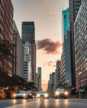 New York City Street at Sunrise with Cars and Skyscrapers
