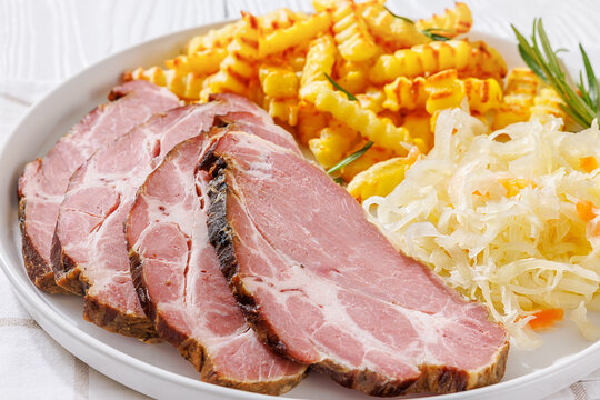 pork neck slices with sour cabbage, french fries