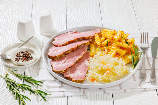 pork neck slices with sour cabbage, french fries
