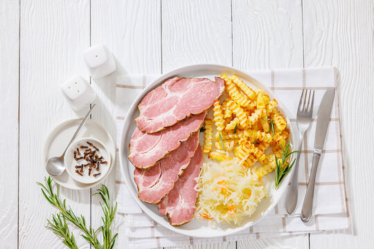 pork neck slices with sour cabbage, french fries