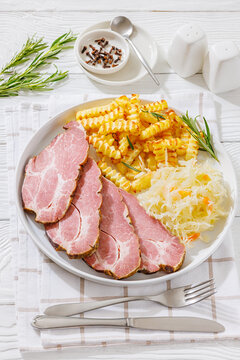 pork neck slices with sour cabbage, french fries