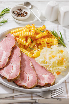 pork neck slices with sour cabbage, french fries