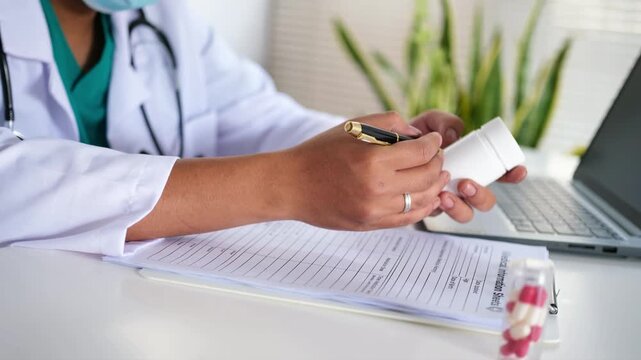 A doctor holds a bottle of pills, explains the prescription, how to use it, or the dosage to a patient, recommends quality medications, and demonstrates the concept of healthcare and treatment.
