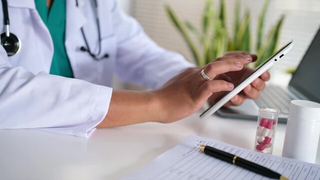 Doctors scroll and type on smartphones in hospitals for research, communication, or health care news. They use smartphones and type in clinics for electronic medical records and mobile health apps.

