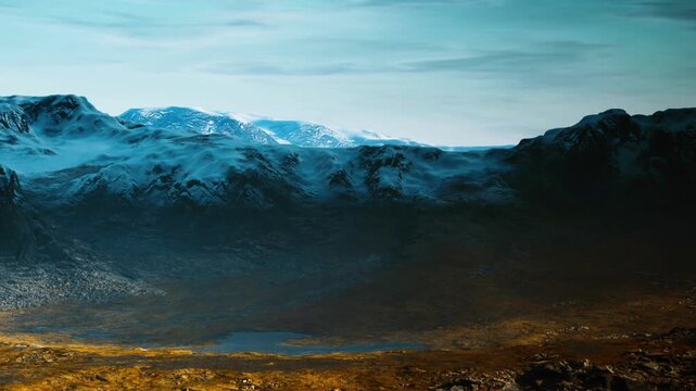 Rocky terrain stretches across the landscape with tall mountains in the background and patches of snow visible on the peaks. The flat grasslands lie below, reflecting sunlight.