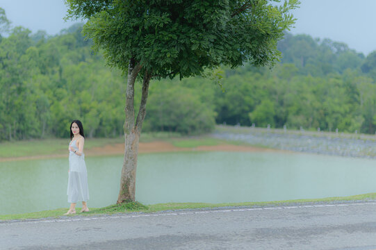 Serene Woman in White Outfit Enjoying Nature in Khao Yai Thailand