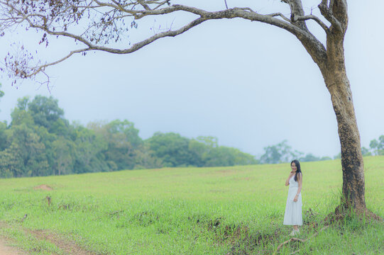 Woman in White Outfit Standing Gracefully in Khao Yai, Thailand