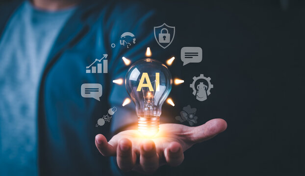 Light bulb with AI logo in hand representing idea and innovation in artificial intelligence.