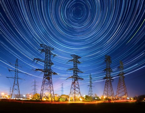 sustainable data center power electric towers illuminated against a night sky with light trails representing energy flow