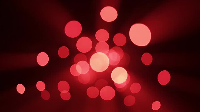 Soft red bokeh lights create a festive and warm atmosphere on a dark background.