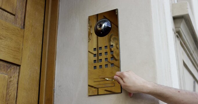 Close up of a hand using a brass contactless tool to press a button on a bus ticket validator