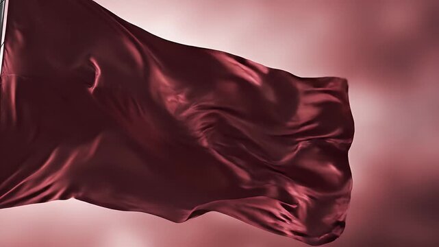 A deep red flag billows softly against a gradient pink background.