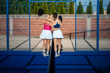 Women players showing friendship and teamwork on padel court © Zoran Jesic