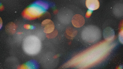 Abstract dark background overlay with retro analog film grain, grunge texture, damaged scratches and dust particles, featuring cinematic multicolor rainbow light leaks, glowing bokeh, and chromatic ab © ale studio 