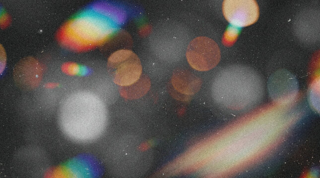 Abstract dark background overlay with retro analog film grain, grunge texture, damaged scratches and dust particles, featuring cinematic multicolor rainbow light leaks, glowing bokeh, and chromatic ab