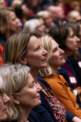 Obraz premium Engaged Conference Attendees Networking Enthusiastically in Brightly Lit Meeting Room, Sparkling with Ideas and Diverse Perspectives