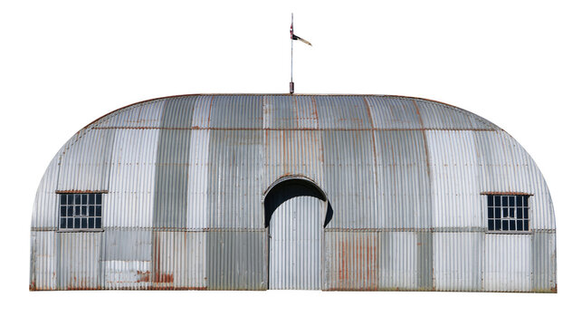 Corrugated metal Quonset hut with arched doorway and windows