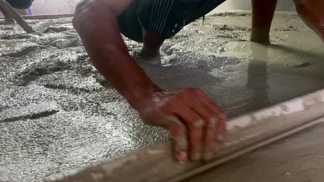 A group of construction workers working on the foundation and steel structures of a building at a construction site during International Labor Day.