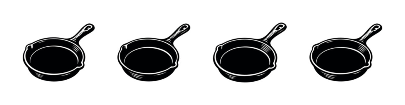 Collection of four black cast iron skillets with handles on a white background