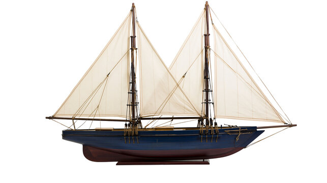 Two-masted schooner model with white sails and blue hull