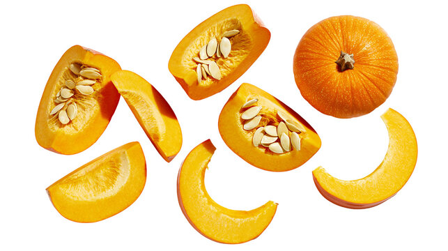 Orange pumpkin pieces and whole pumpkin scattered