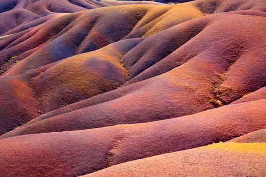 The &ldquo;Seven Coloured Earths&ldquo; are a geological formation and tourist attraction in the Chamarel plain in Mauritius. Sand dunes in red, brown, violet, green, blue, purple, yellow. Natural background.