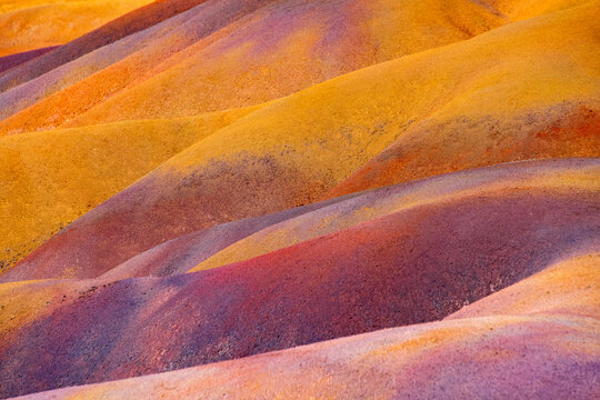 The &ldquo;Seven Coloured Earths&ldquo; are a geological formation and tourist attraction in the Chamarel plain in Mauritius. Sand dunes in red, brown, violet, green, blue, purple, yellow. Natural background.