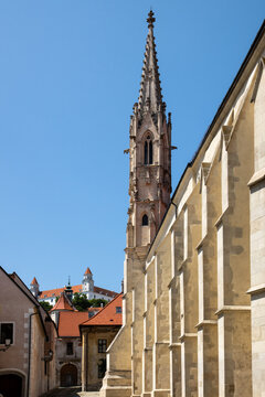 Historic Gothic cathedral spire and cobblestone street in Bratislava