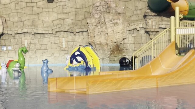 Yellow water slide in indoor pool area