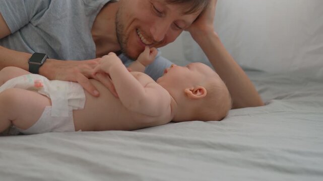 Father talking face to face with his three month old baby son. Slow motion.