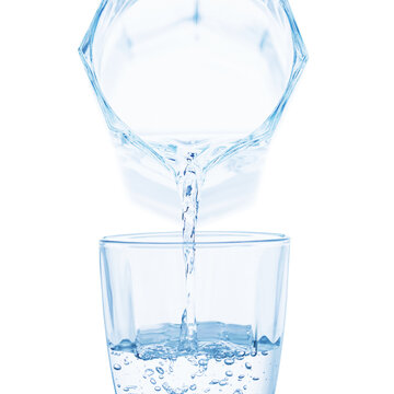 clear water flows from decanter filling glass isolated on white