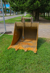 Excavator bucket placed on grass © Cat_Kiti_cat