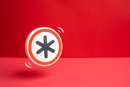 A symbol with an asterisk on a red background. Hidden terms and pitfalls in a contract. Legal review of a contract.