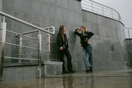 Two female friends walking outdoors on an autumn day