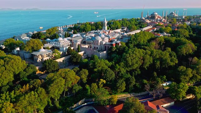 Aerial view of Topkapi Palace Museum and its surrounding parkland in Istanbul, Turkey. The palace stands above lush greenery with panoramic views toward the Bosphorus.