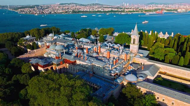 Aerial view of Topkapi Palace Museum in Istanbul, Turkey. The historic palace complex overlooks the Bosphorus and is surrounded by trees, courtyards and elegant Ottoman buildings.