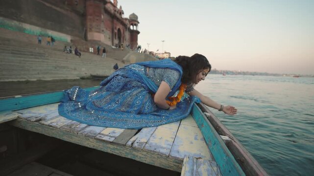 An Indian Traditional girl on a Boat in Ganges River Varanasi
