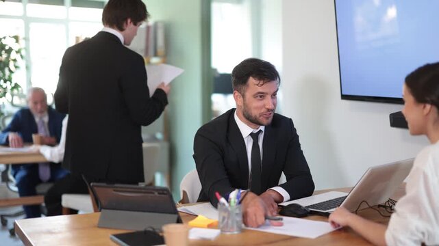 Qualified bank employee tells a female client about deposits, obtaining a loan and a savings account. Woman talking to specialist in office interior. High quality 4k footage