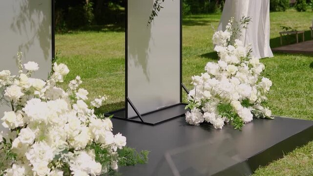 Decor and floristry for a wedding arch made of white flowers for the bride and groom ceremony