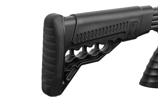 Close-up of a black tactical shotgun buttstock with a rubber recoil pad on a white back