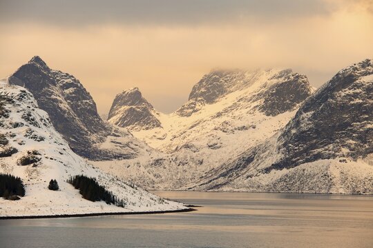 Winter Scandinavian landscape by the fjord, sea, mountains, snow, Ramberg, Nordland, Lofoten, Norway