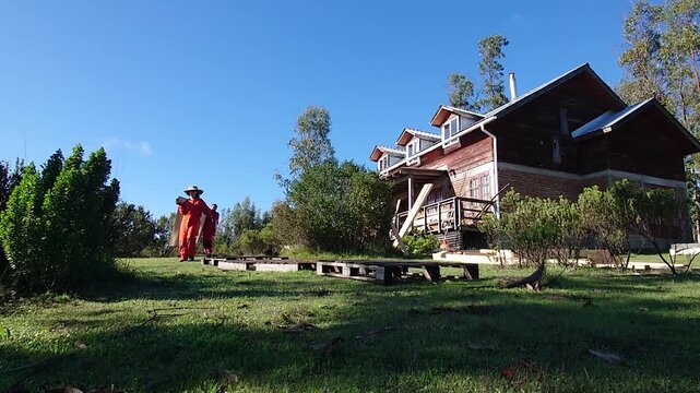 Woman Working in Male Dominated Construction Field Carrying Large Wooden Panel with Male Coworker Near a Rural Property or house on a green landscape: Teamwork and Equality in Blue Collar jobs
