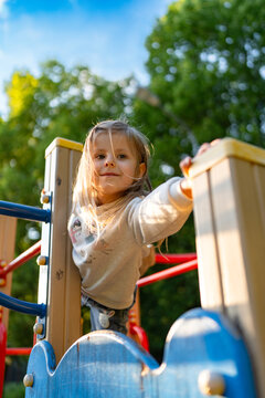 Cute beautiful smiling little girl on the playground for fun, games or recreation. Face and happy with adorable kid outdoor for development, growth or recess in summer.